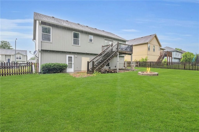22005 Gracie Dr, Peculiar, MO 64078 - back of house featuring stairs, an outdoor fire pit, a deck, and a fenced backyard