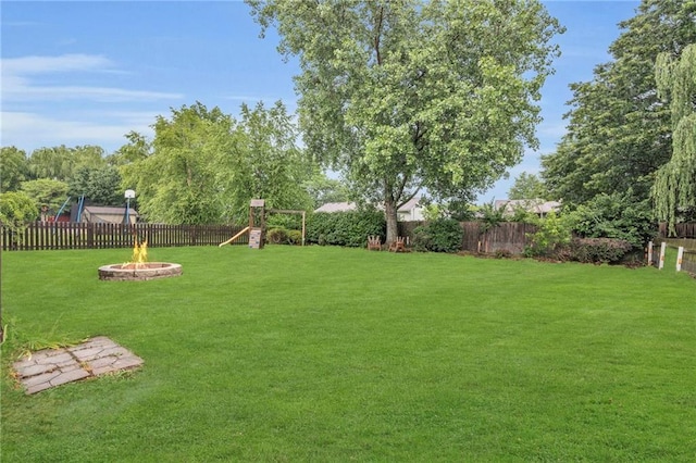 22005 Gracie Dr, Peculiar, MO 64078 - fenced backyard with an outdoor fire pit