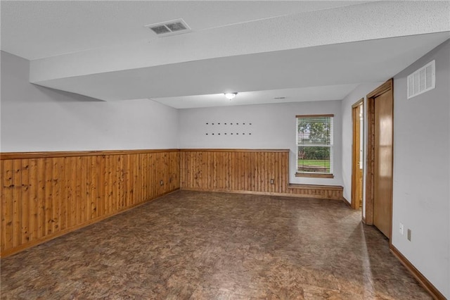 22005 Gracie Dr, Peculiar, MO 64078 - unfurnished room featuring wainscoting, wood walls, and tile patterned floors