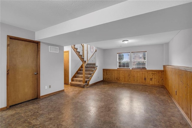 22005 Gracie Dr, Peculiar, MO 64078 - basement featuring a wainscoted wall, stairs, tile patterned floors, and wooden walls