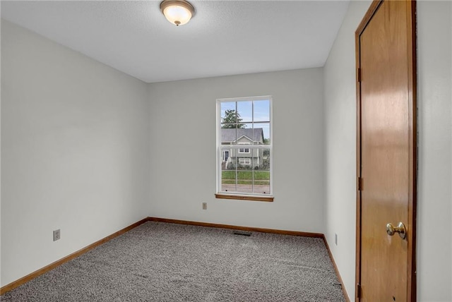 22005 Gracie Dr, Peculiar, MO 64078 - spare room featuring carpet flooring and a textured ceiling