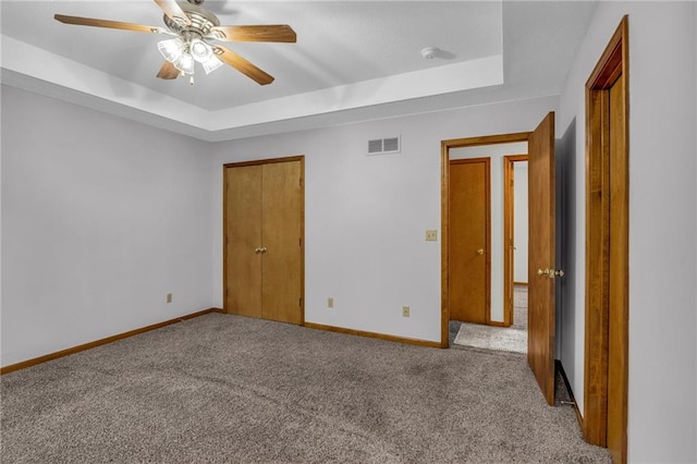 22005 Gracie Dr, Peculiar, MO 64078 - unfurnished bedroom with a tray ceiling, carpet flooring, and a closet