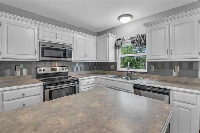 22005 Gracie Dr, Peculiar, MO 64078 - kitchen with appliances with stainless steel finishes, white cabinets, and a textured ceiling