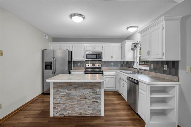 22005 Gracie Dr, Peculiar, MO 64078 - kitchen featuring appliances with stainless steel finishes, light countertops, white cabinetry, decorative backsplash, and a textured ceiling