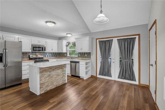 22005 Gracie Dr, Peculiar, MO 64078 - kitchen featuring stainless steel appliances, light countertops, white cabinets, vaulted ceiling, and dark wood-type flooring