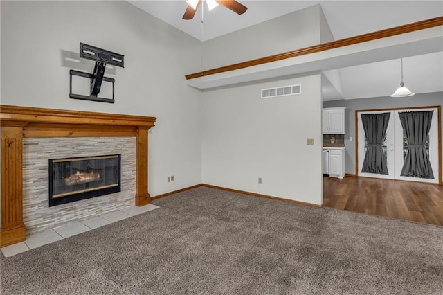 22005 Gracie Dr, Peculiar, MO 64078 - unfurnished living room featuring carpet floors, ceiling fan, and a stone fireplace