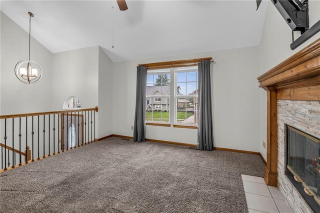 22005 Gracie Dr, Peculiar, MO 64078 - unfurnished living room featuring vaulted ceiling, light colored carpet, a ceiling fan, a chandelier, and a stone fireplace