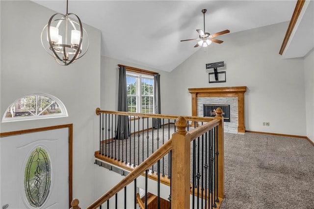 22005 Gracie Dr, Peculiar, MO 64078 - carpeted foyer with a ceiling fan, a chandelier, lofted ceiling, and a glass covered fireplace