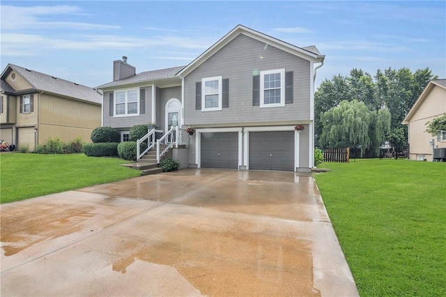 22005 Gracie Dr, Peculiar, MO 64078 - bi-level home featuring a garage, a chimney, a front yard, and driveway
