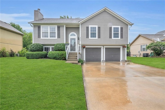 22005 Gracie Dr, Peculiar, MO 64078 - raised ranch with an attached garage, a front lawn, a chimney, and driveway