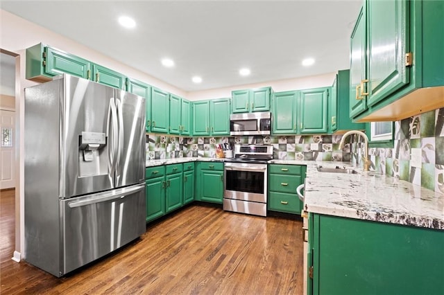 1521 W 22nd St, Lawrence, KS 66046 - kitchen featuring appliances with stainless steel finishes, dark wood finished floors, decorative backsplash, and recessed lighting