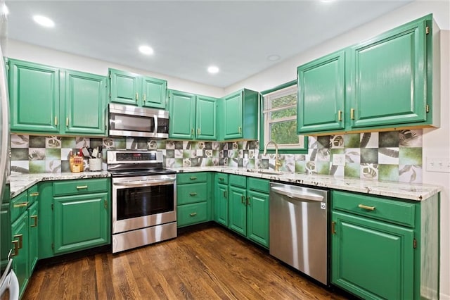 1521 W 22nd St, Lawrence, KS 66046 - kitchen with stainless steel appliances, backsplash, dark wood-style flooring, and recessed lighting