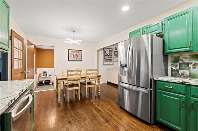 1521 W 22nd St, Lawrence, KS 66046 - kitchen featuring stainless steel appliances, dark wood-style floors, a chandelier, light stone countertops, and recessed lighting