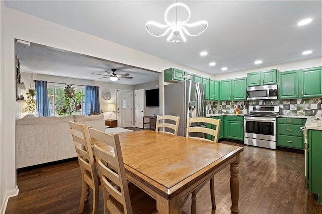 1521 W 22nd St, Lawrence, KS 66046 - dining space with dark wood-style floors, recessed lighting, a ceiling fan, and a chandelier