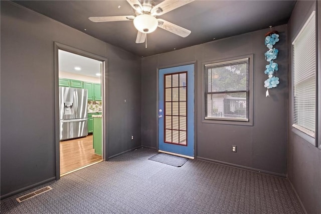 1521 W 22nd St, Lawrence, KS 66046 - carpeted empty room with baseboards and a ceiling fan