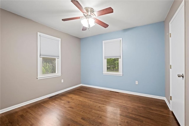 1521 W 22nd St, Lawrence, KS 66046 - unfurnished room with healthy amount of natural light, wood finished floors, and a ceiling fan