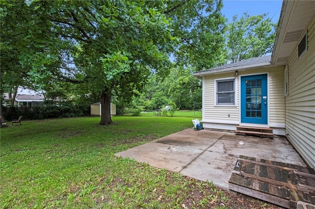 1521 W 22nd St, Lawrence, KS 66046 - view of green lawn featuring a patio area, a storage unit, and entry steps