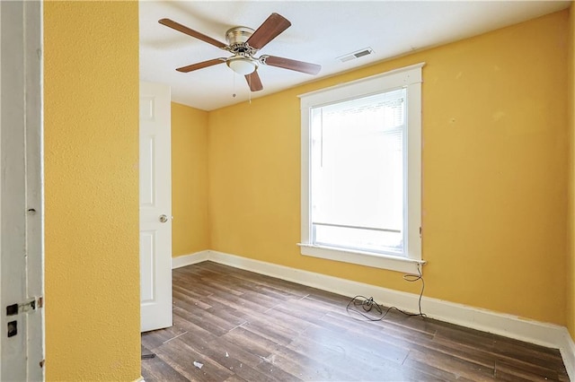 2512 Jules St, Saint Joseph, MO 64501 - empty room with wood finished floors, plenty of natural light, and a ceiling fan