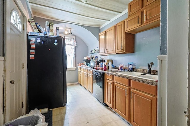 2512 Jules St, Saint Joseph, MO 64501 - kitchen featuring black appliances, light flooring, and brown cabinets