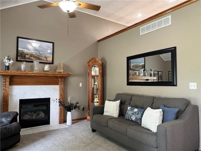 938 S 17th St, Leavenworth, KS 66048 - carpeted living room featuring ceiling fan, ornamental molding, an ornate ceiling, and a tile fireplace