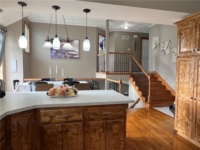 938 S 17th St, Leavenworth, KS 66048 - kitchen featuring wood finished floors, decorative light fixtures, and light countertops