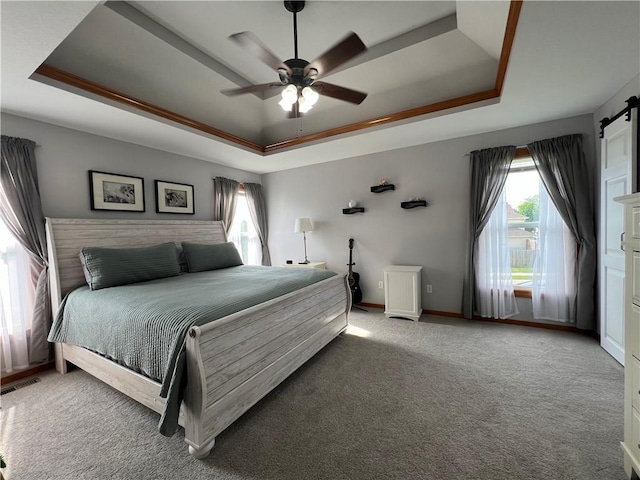 938 S 17th St, Leavenworth, KS 66048 - carpeted bedroom with a raised ceiling, a barn door, and ceiling fan