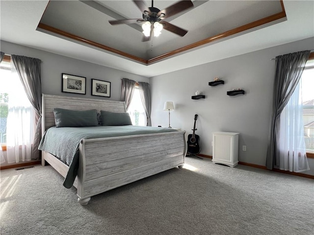 938 S 17th St, Leavenworth, KS 66048 - carpeted bedroom with a raised ceiling and ceiling fan