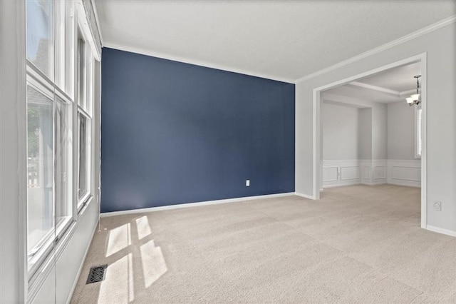 18970 W 115th Ter, Olathe, KS 66061 - empty room with ornamental molding, carpet flooring, a chandelier, a decorative wall, and wainscoting