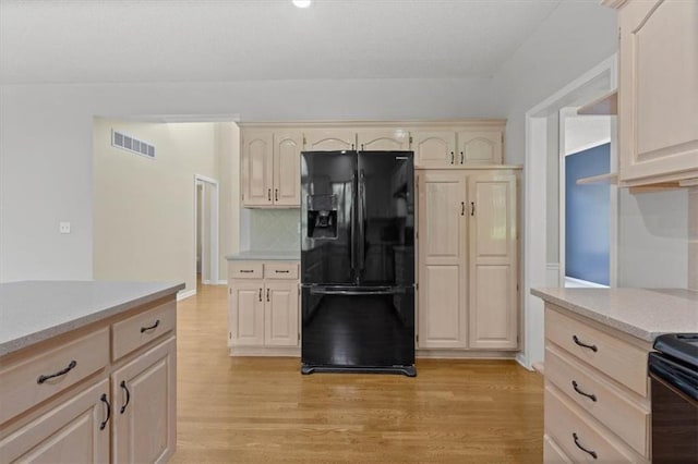 18970 W 115th Ter, Olathe, KS 66061 - kitchen featuring black fridge with ice dispenser, light countertops, tasteful backsplash, light wood-style flooring, and light brown cabinets