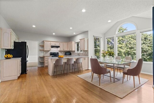 18970 W 115th Ter, Olathe, KS 66061 - dining area featuring healthy amount of natural light, a textured ceiling, light wood-type flooring, recessed lighting, and lofted ceiling
