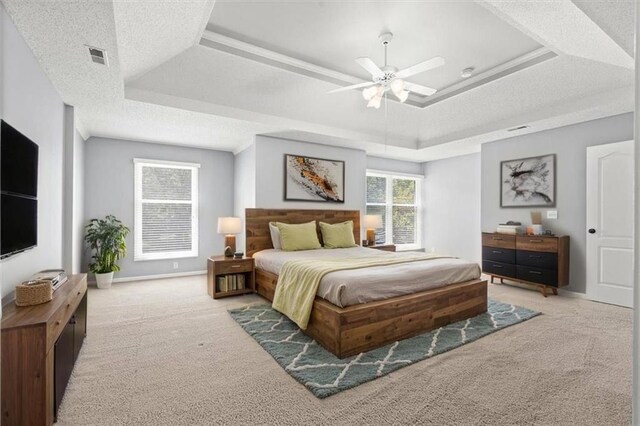 18970 W 115th Ter, Olathe, KS 66061 - bedroom with light colored carpet, a raised ceiling, and ceiling fan