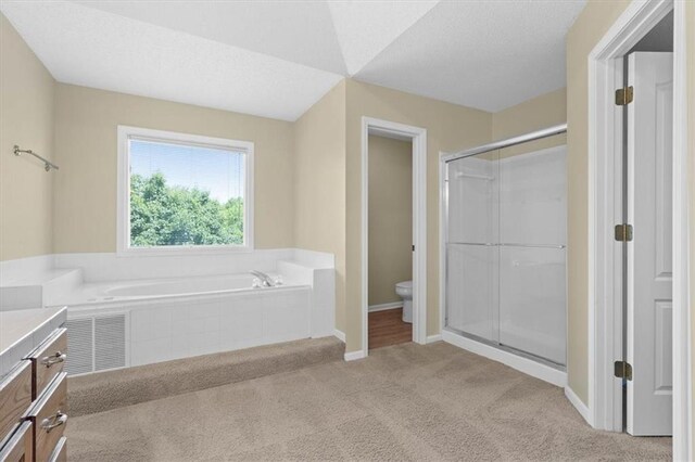 18970 W 115th Ter, Olathe, KS 66061 - bathroom featuring vanity, a bath, a stall shower, and carpet