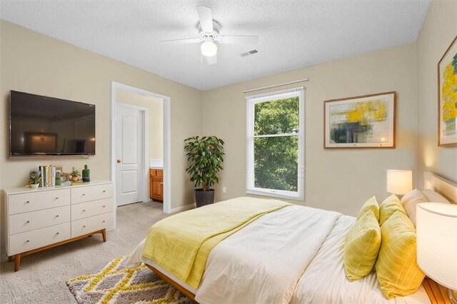 18970 W 115th Ter, Olathe, KS 66061 - bedroom featuring light carpet, a textured ceiling, ensuite bath, and a ceiling fan