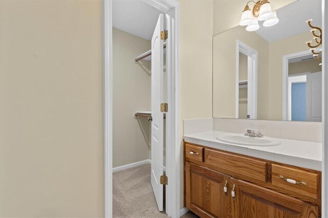 18970 W 115th Ter, Olathe, KS 66061 - bathroom with vanity and a spacious closet