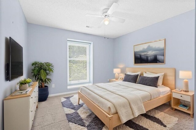 18970 W 115th Ter, Olathe, KS 66061 - bedroom with light colored carpet, a textured ceiling, and a ceiling fan