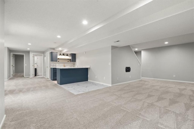 18970 W 115th Ter, Olathe, KS 66061 - unfurnished living room featuring recessed lighting, light colored carpet, and bar with sink
