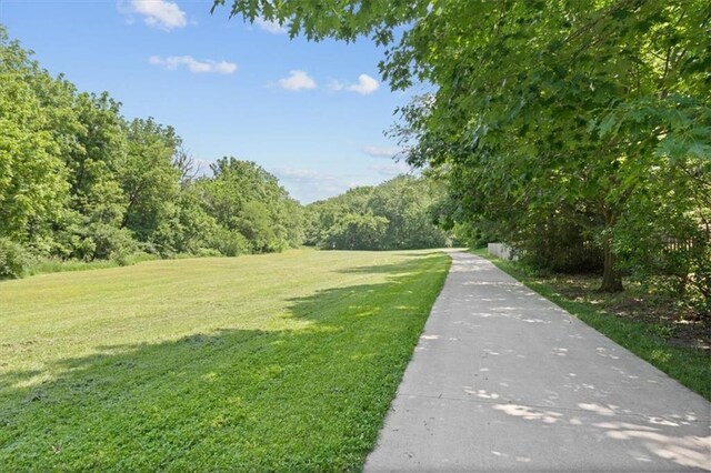 18970 W 115th Ter, Olathe, KS 66061 - view of property's community with a yard and a view of trees