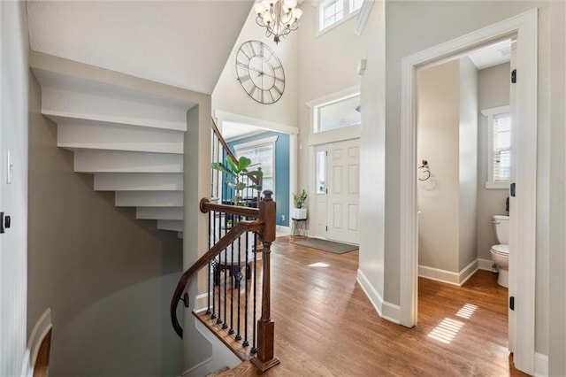 936 SW Raintree Dr, Lees Summit, MO 64082 - entryway featuring healthy amount of natural light, wood finished floors, a towering ceiling, and stairway