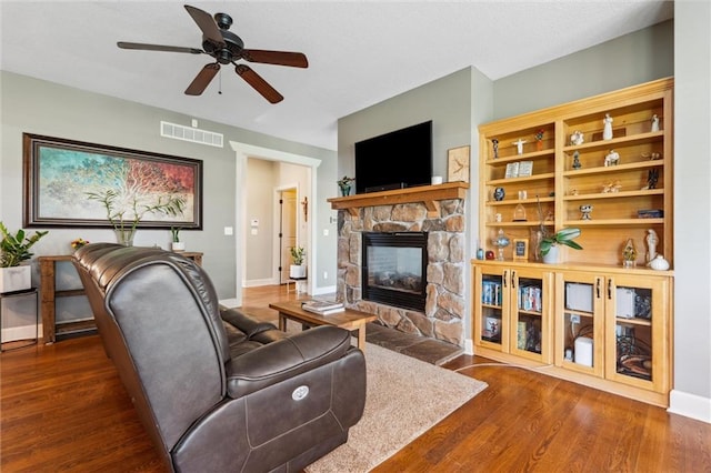 936 SW Raintree Dr, Lees Summit, MO 64082 - living area with a stone fireplace, wood finished floors, and a ceiling fan