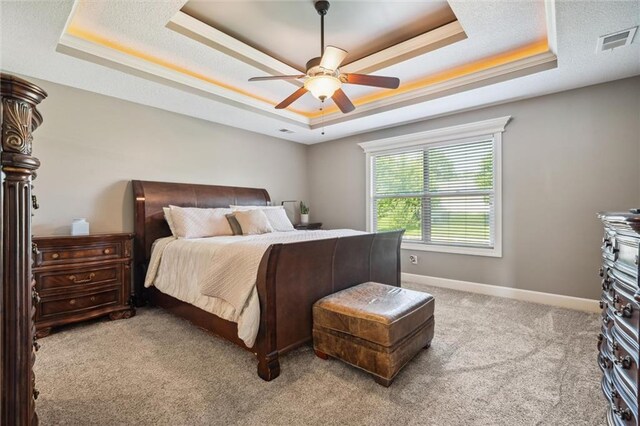 936 SW Raintree Dr, Lees Summit, MO 64082 - bedroom with a tray ceiling, carpet, and a ceiling fan