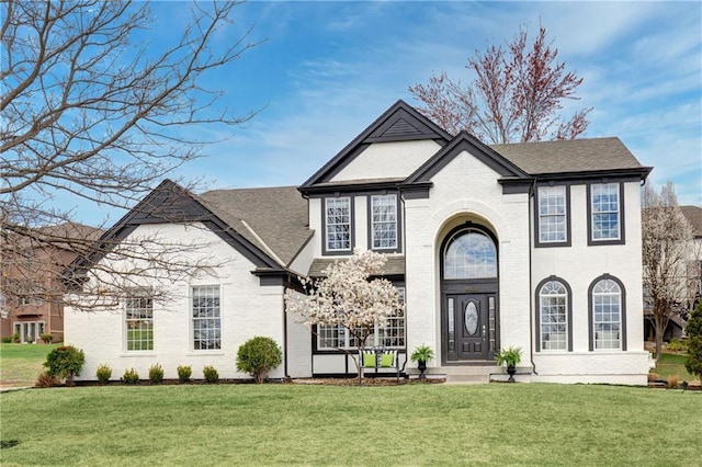 14600 Reinhardt Ln, Leawood, KS 66224 - view of front of property with a front lawn, brick siding, and roof with shingles