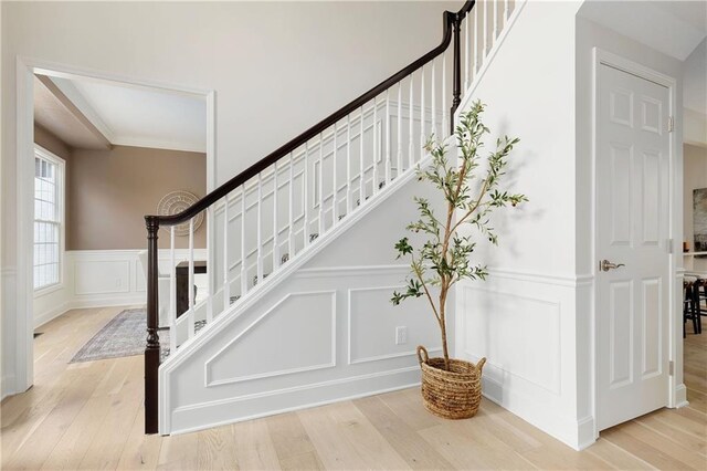 14600 Reinhardt Ln, Leawood, KS 66224 - stairway with a decorative wall, wood finished floors, and wainscoting