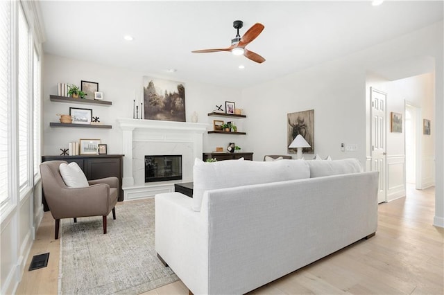 14600 Reinhardt Ln, Leawood, KS 66224 - living room featuring healthy amount of natural light, ceiling fan, light wood-style floors, a high end fireplace, and recessed lighting