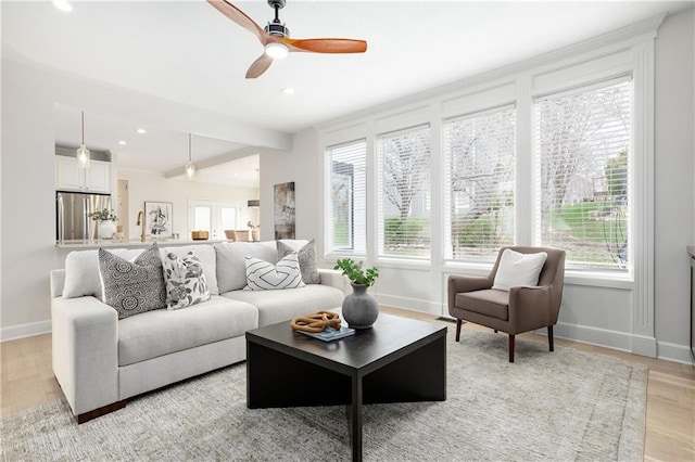 14600 Reinhardt Ln, Leawood, KS 66224 - living room featuring plenty of natural light, ceiling fan, light wood-type flooring, recessed lighting, and beam ceiling