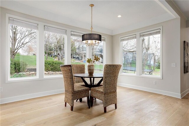 14600 Reinhardt Ln, Leawood, KS 66224 - dining area featuring light wood-style floors, a chandelier, and a tray ceiling
