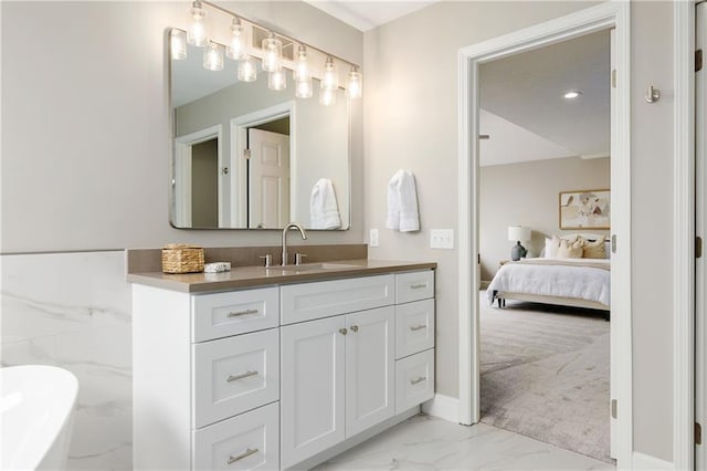 14600 Reinhardt Ln, Leawood, KS 66224 - ensuite bathroom with marble finish floors, vanity, and a soaking tub