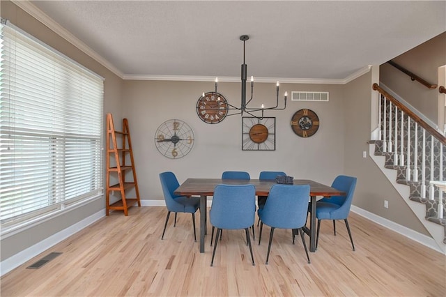 5303 Hallet St, Shawnee, KS 66216 - dining area with stairs, light wood-type flooring, a chandelier, and ornamental molding