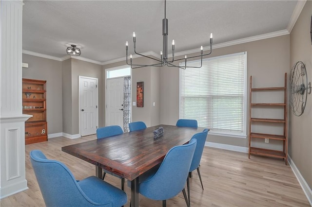 5303 Hallet St, Shawnee, KS 66216 - dining space featuring a chandelier, light wood finished floors, a textured ceiling, decorative columns, and ornamental molding