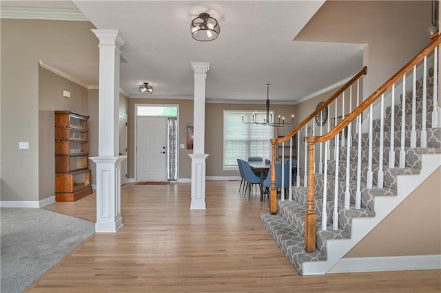 5303 Hallet St, Shawnee, KS 66216 - entryway with ornate columns, light wood-style floors, crown molding, and stairs