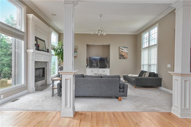 5303 Hallet St, Shawnee, KS 66216 - living area featuring ornate columns, a ceiling fan, ornamental molding, a tile fireplace, and wood finished floors